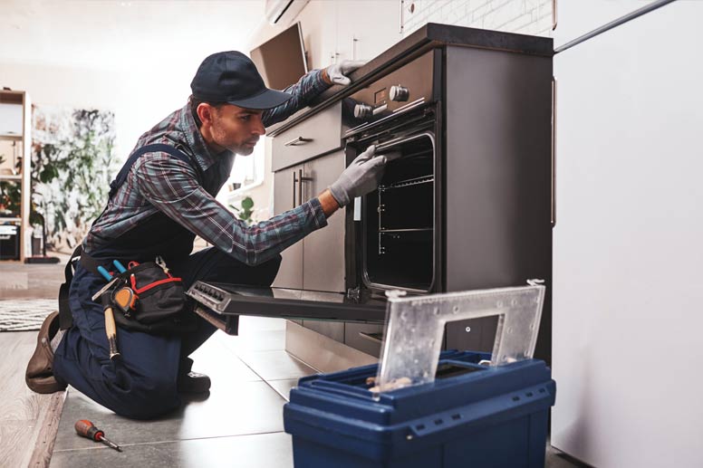 How To Get Your Appliance Repair Certification: Technician repairing an oven