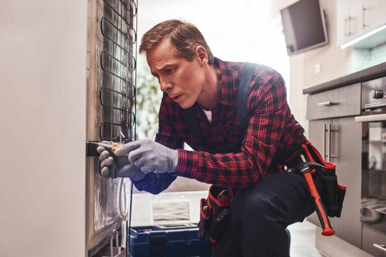 How To Get Your Appliance Repair Certification: Technician repairing a fridge