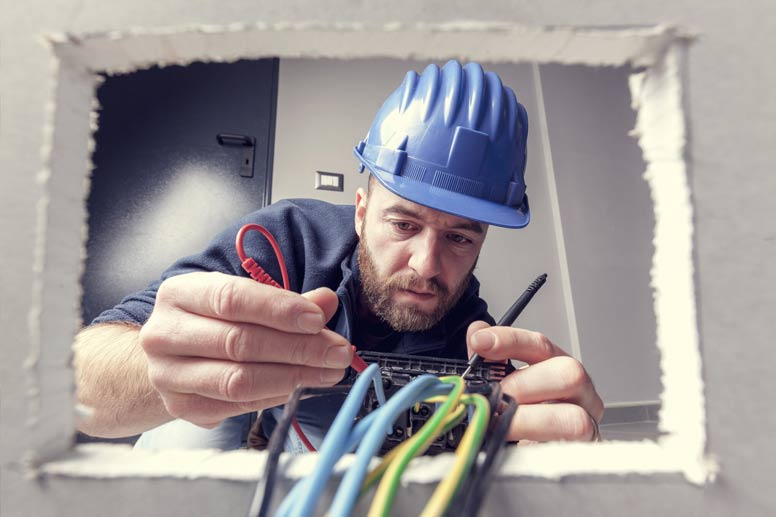 How To Get An Electrical License: Electrician Connecting Cables