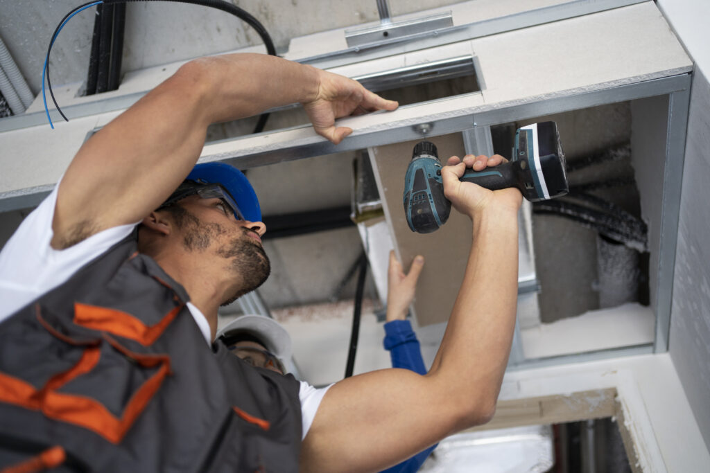 Roofing employee closing up ventilation roof
