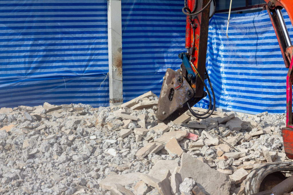 Concrete cutting with construction excavator
