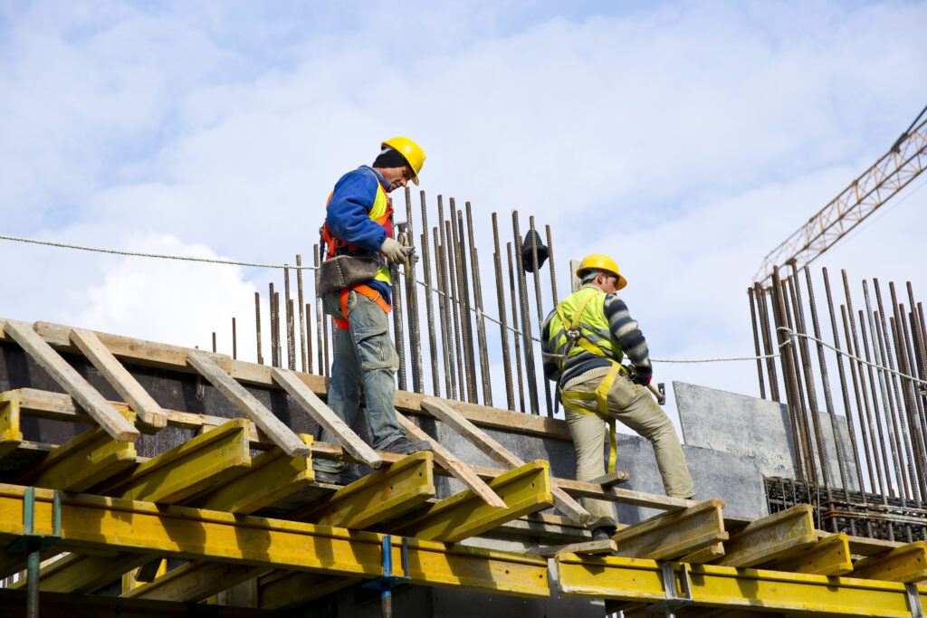 Men working at heights on a construction site wearing PPE for safety