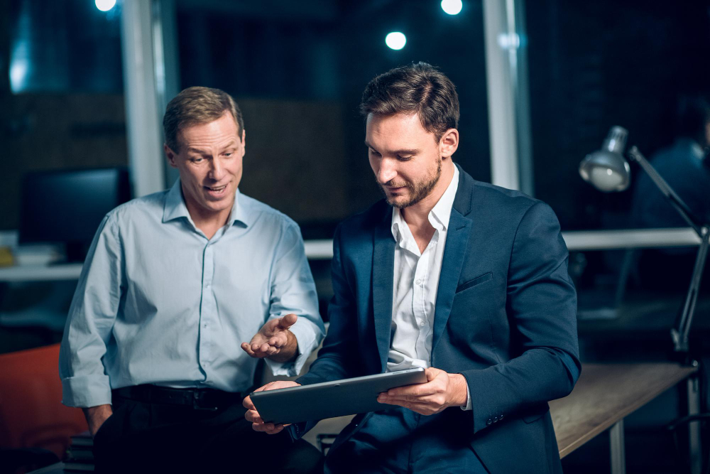 Close-up of entrepreneur and consultant discussing business formation paperwork.
