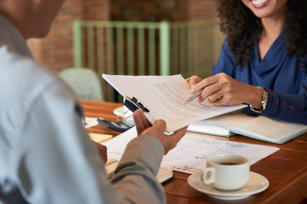 Business owner and advisor reviewing legal documents and business structure options.