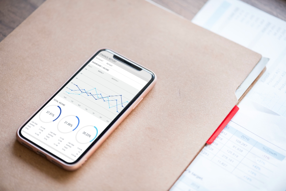 Using mobile phone device to check business analytics.