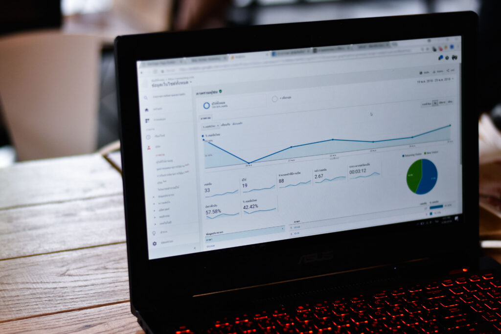 Laptop displaying Google Analytics dashboard with traffic and performance data.