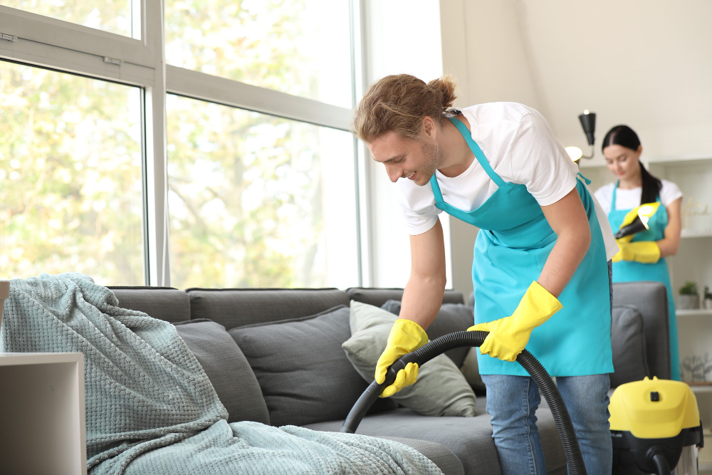 House cleaning contractors cleaning home sofa