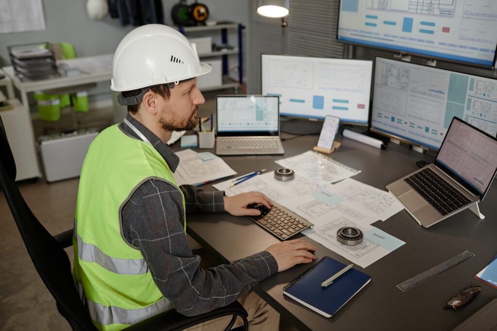 HVAC & Construction Technician at the desktop looking at marketing analytics, checking if there are new leads.
