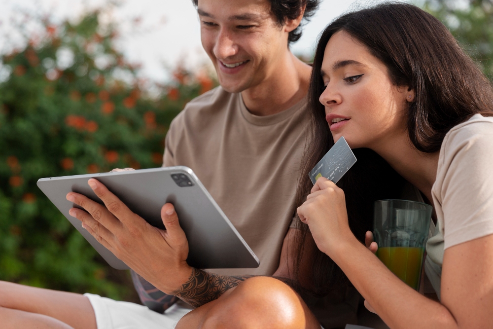 People using a credit card to shop online through a tablet