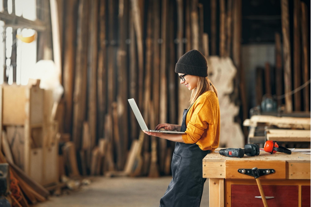 Carpenter business owner using a laptop to design his website.