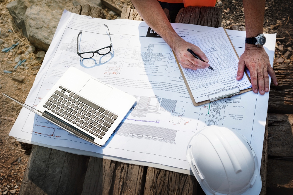 Inspector reviewing construction blueprint