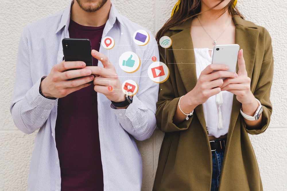 People scrolling social media apps on smartphones, symbolising HVAC social media ad campaigns.