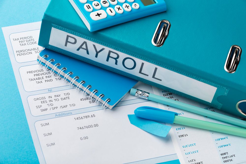 Binder with payroll documents and payslip