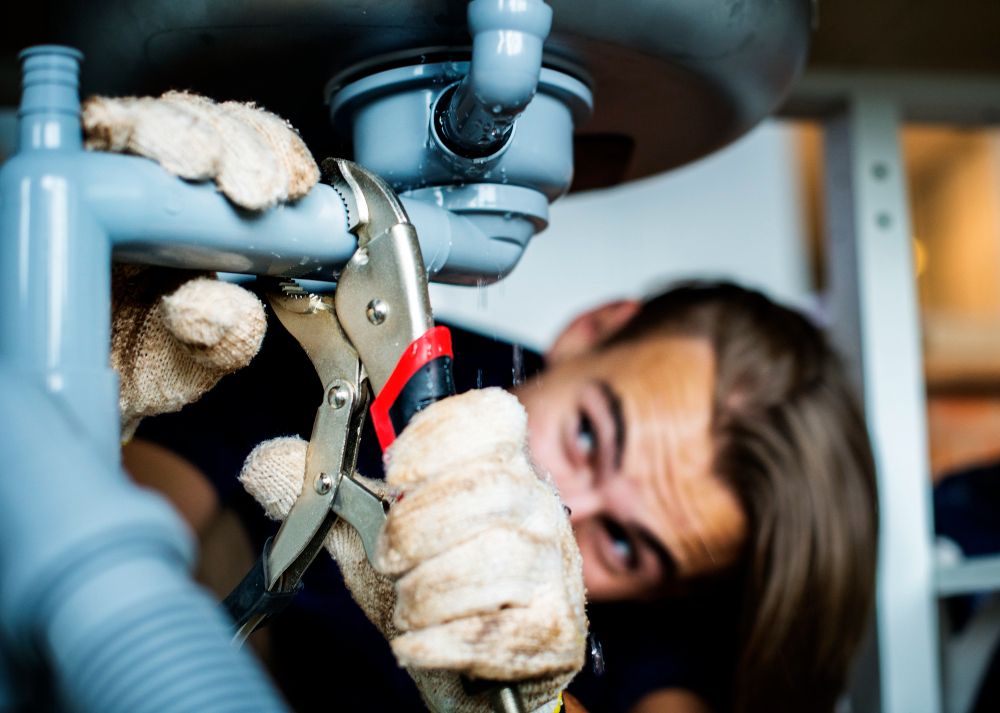 plumbing contractor fixing pipes
