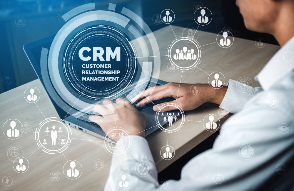 Business professional using CRM software on laptop