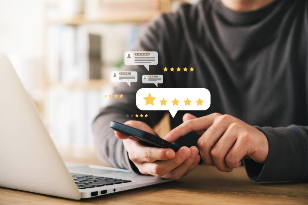 Phone and laptop with review stars and feedback icons
