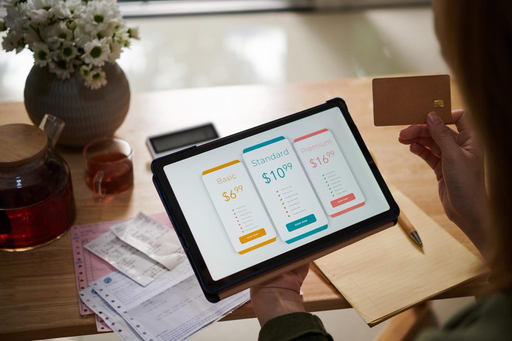 comparing invoicing software pricing on tablet