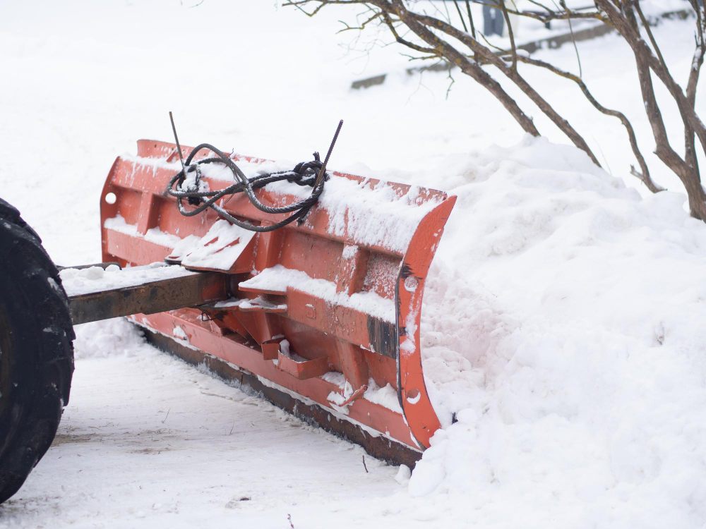 Snow plow pushing snow from a path