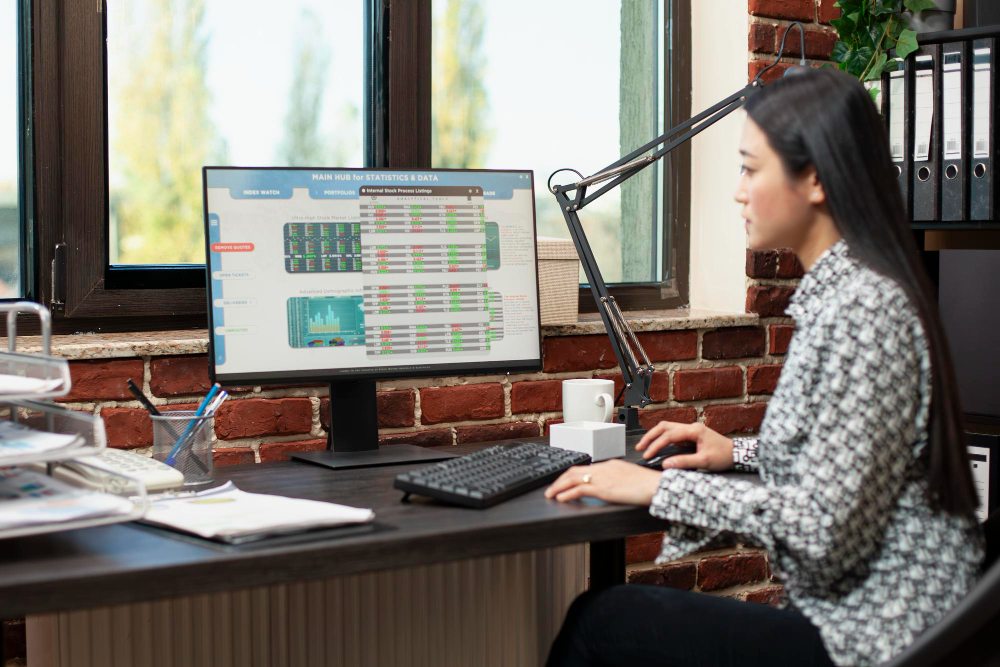 Woman reviewing business reports and cash flow data