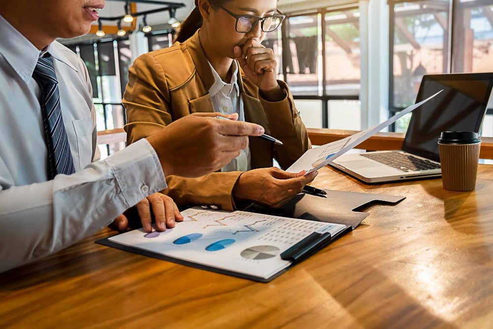 Business meeting reviewing financial statements and reports