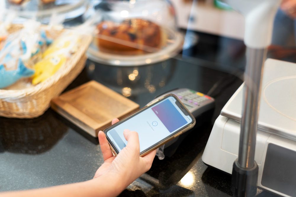 Customer paying with mobile phone at checkout