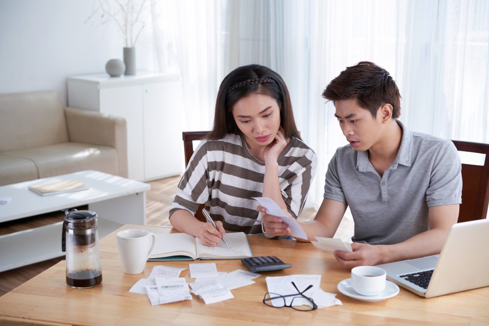 Couple calculating personal finances at home