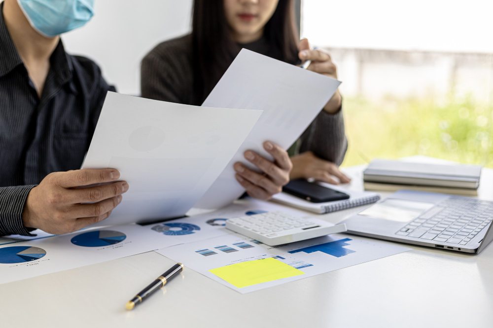 Business professionals reviewing financial documents at desk