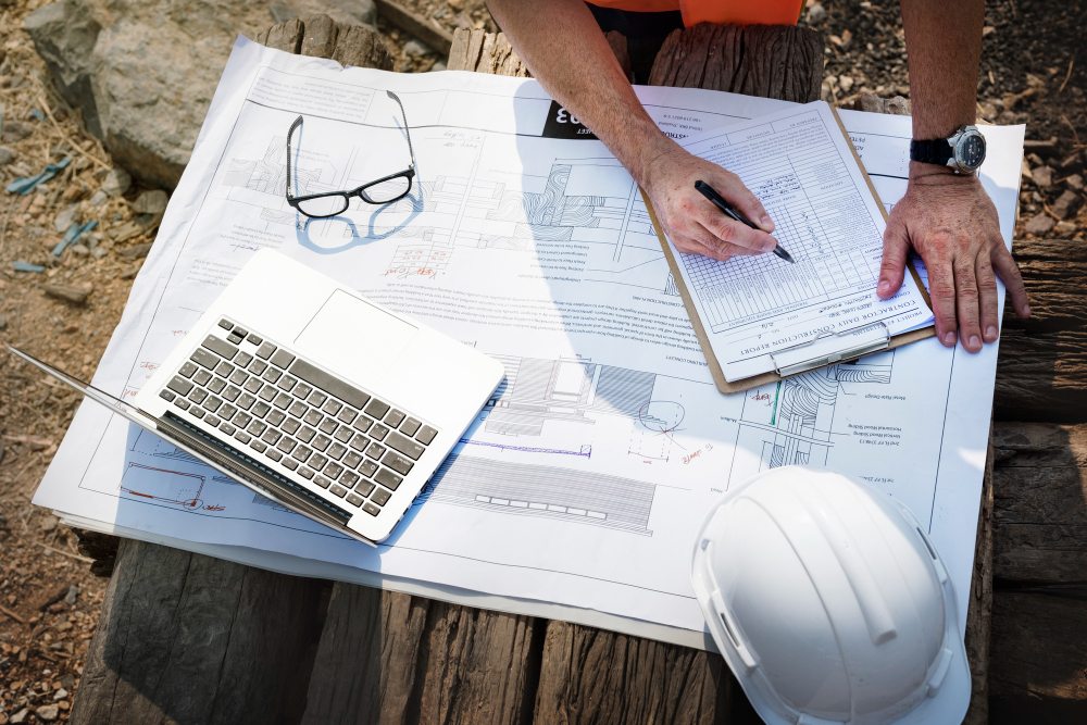 Construction engineer reviewing work order on site