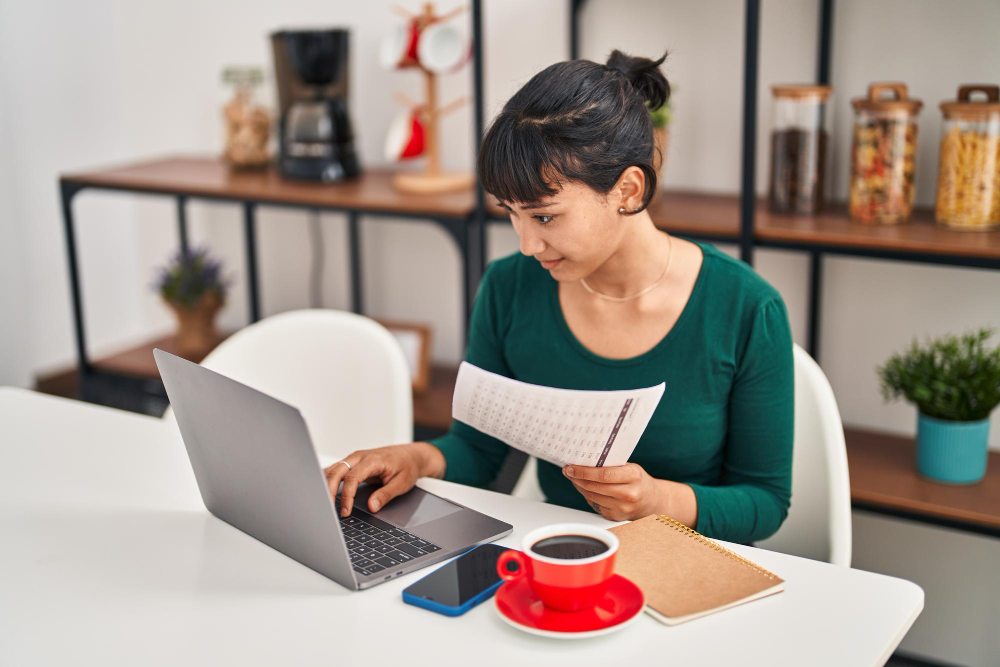 Woman filing a tax return online on a laptop at home