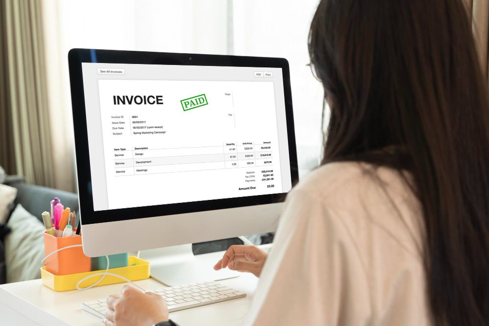 Businesswoman reviewing electronic invoice and EFT payments online