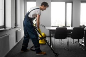 Professional cleaner disinfecting office interior space