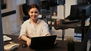 Female entrepreneur using CRM software on laptop