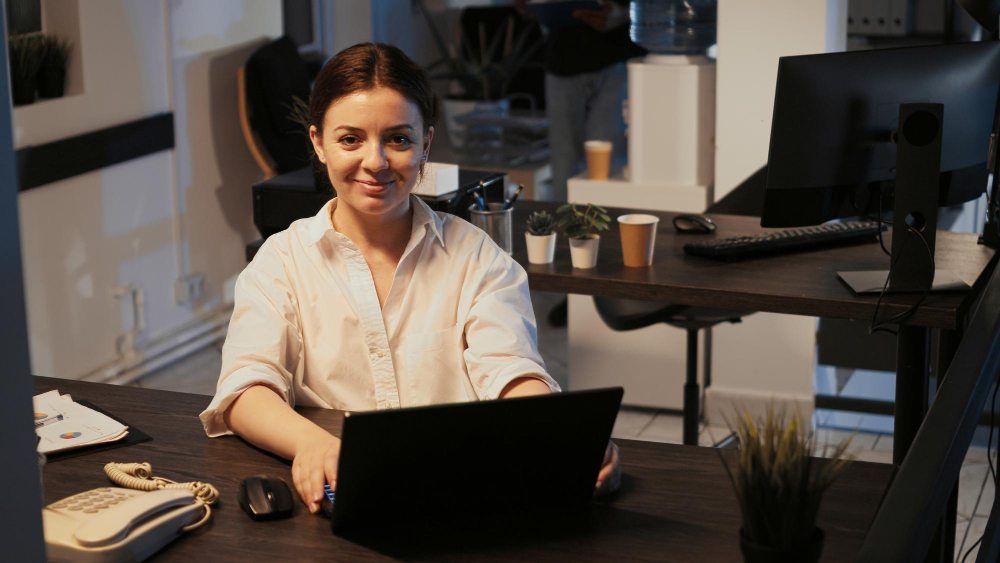 Female entrepreneur using CRM software on laptop