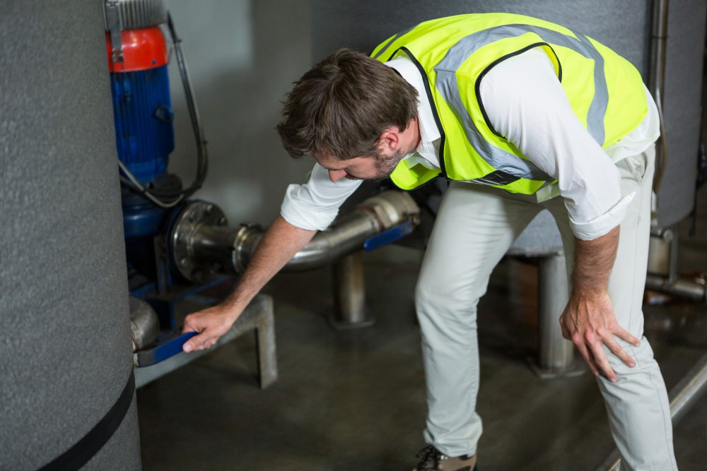 commercial plumbing technician inspecting pipes