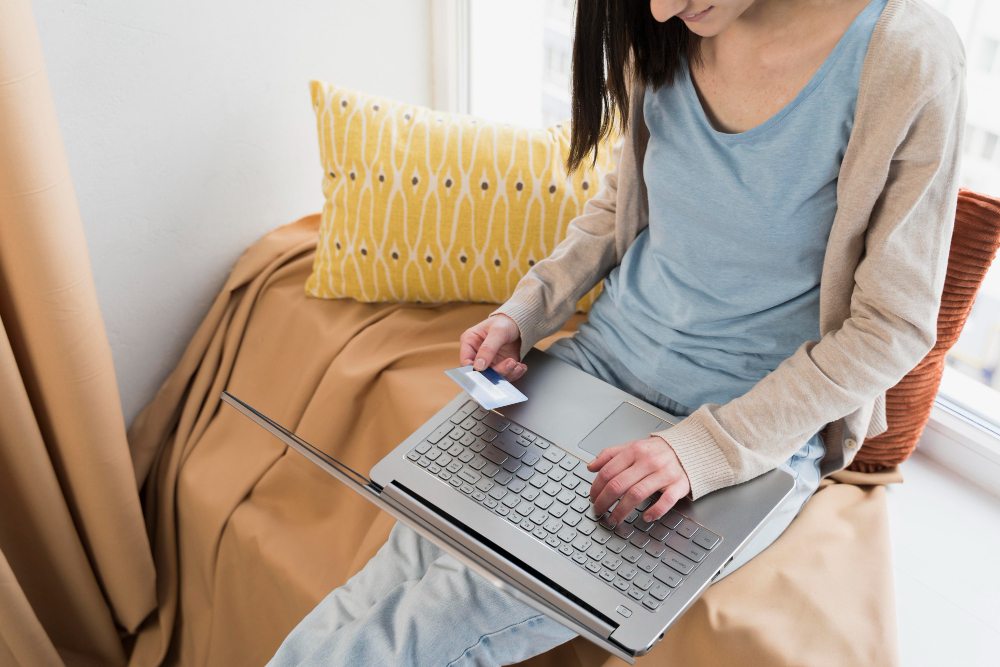 Woman making online payment with laptop and credit card