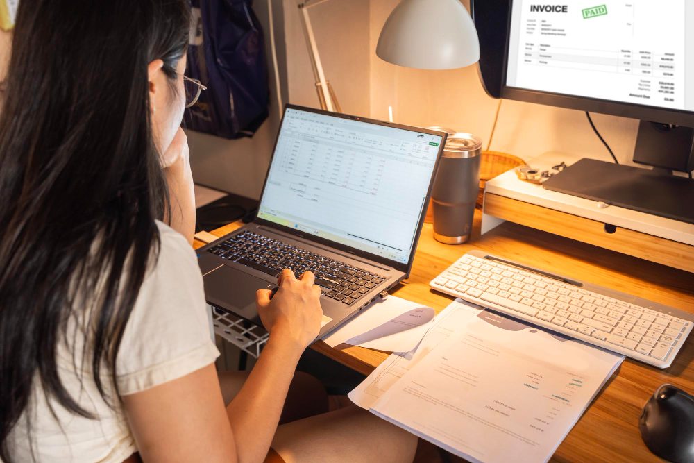 Accountant reviewing sample itemized invoice on computer screen
