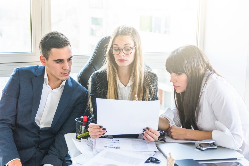Business team reviewing documents together in office