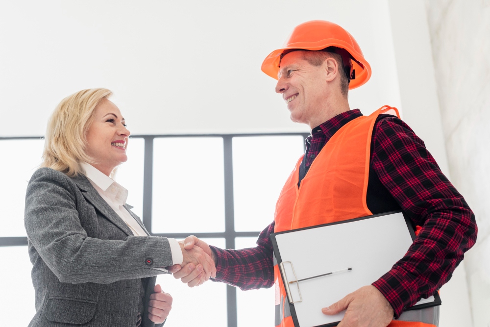 Contractor and client handshake confirming agreement