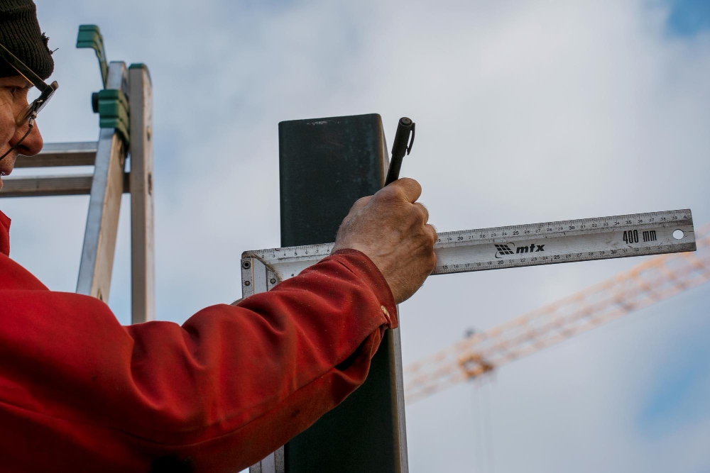 Contractor measuring material with ruler for accurate job planning