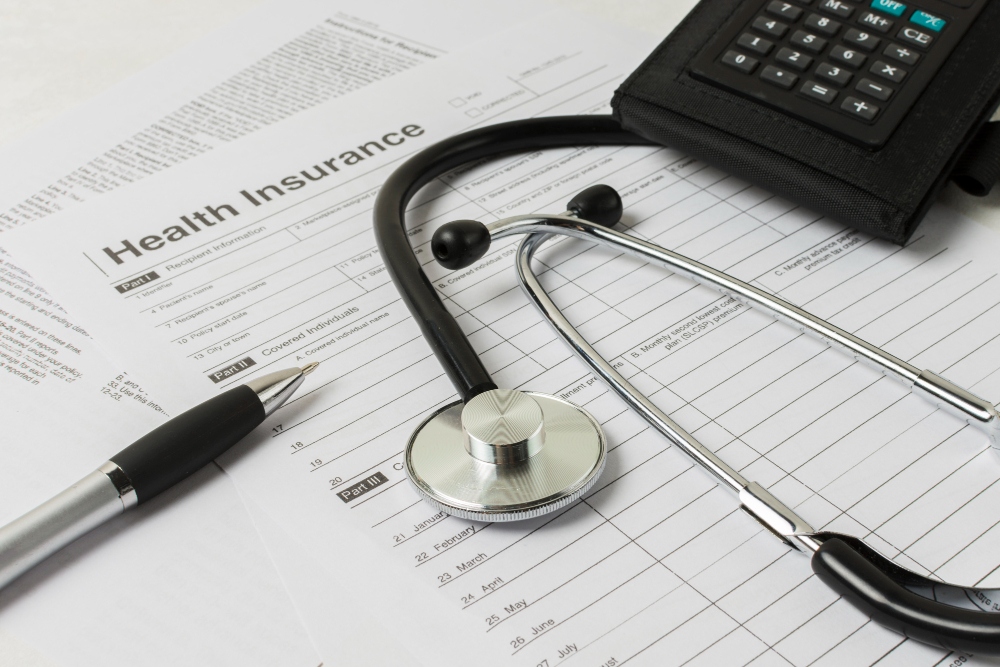 Medical documents and equipment representing health insurance expenses