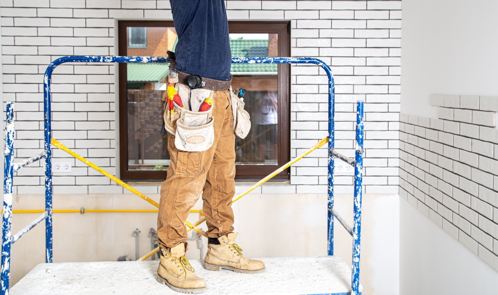 Professional painting contractor painting exterior wall of a house