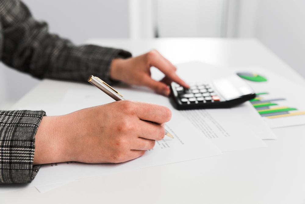 Business professional working on financial documents at desk