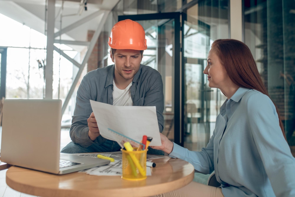 Contractor discussing invoice and billing details with client