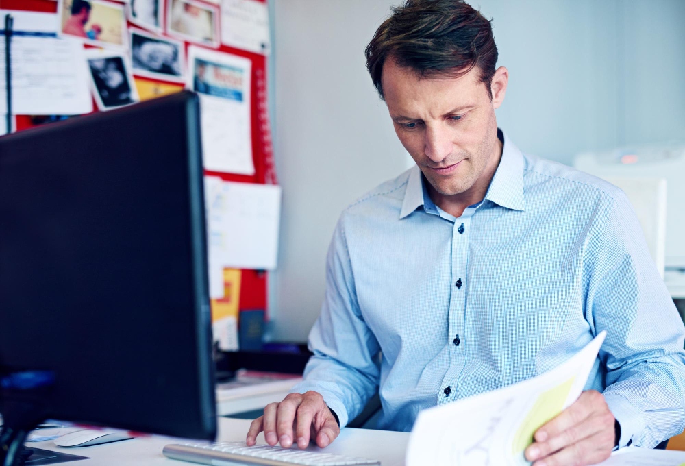 Office staff checking invoice details for accuracy

