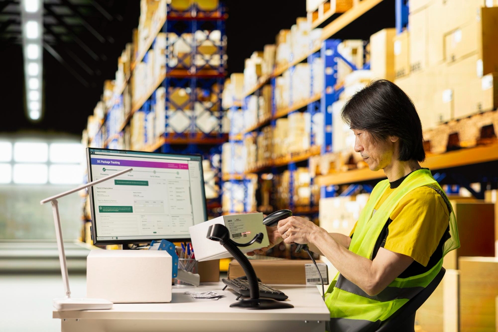 Warehouse worker scanning packages for shipment processing