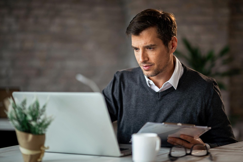 manager reviewing acknowledgement receipt templates on laptop