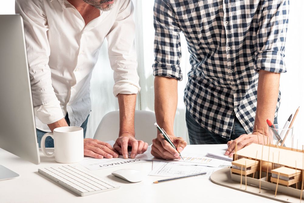 contractor explaining construction price breakdown to homeowner