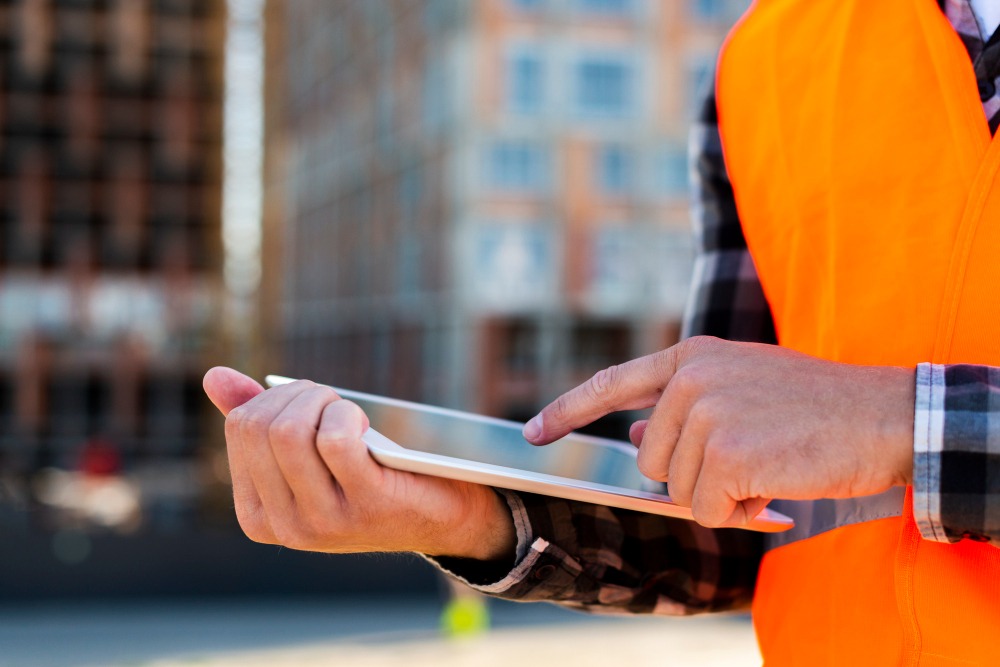 crew leader using contractor time tracking app on site