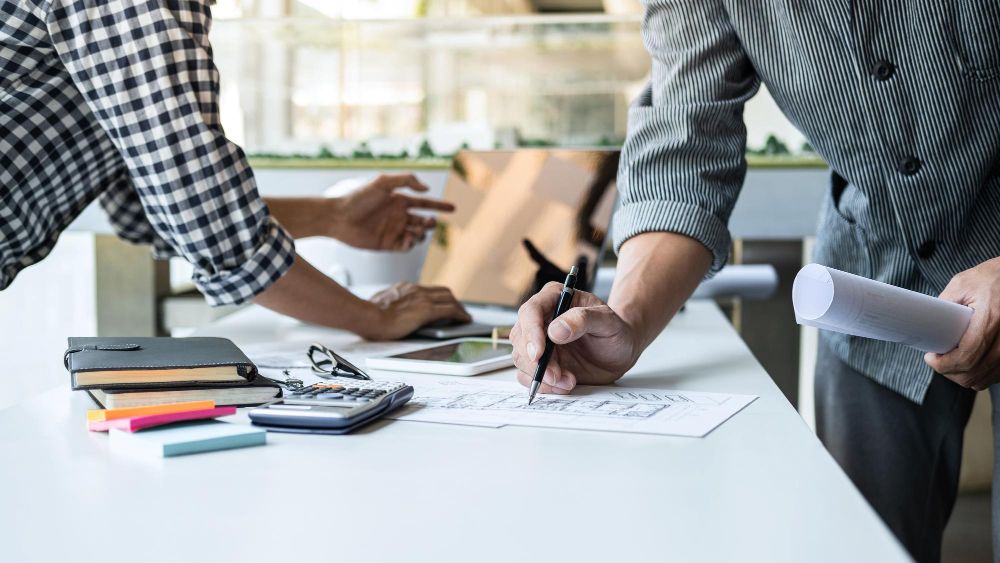 Contractor managing project budget and paperwork in office