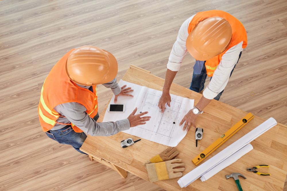 Construction professionals discussing blueprints and project planning